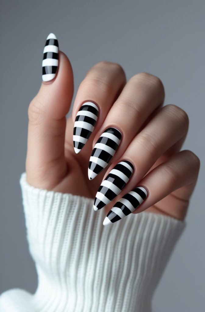15. Black and White Striped Stiletto Nails