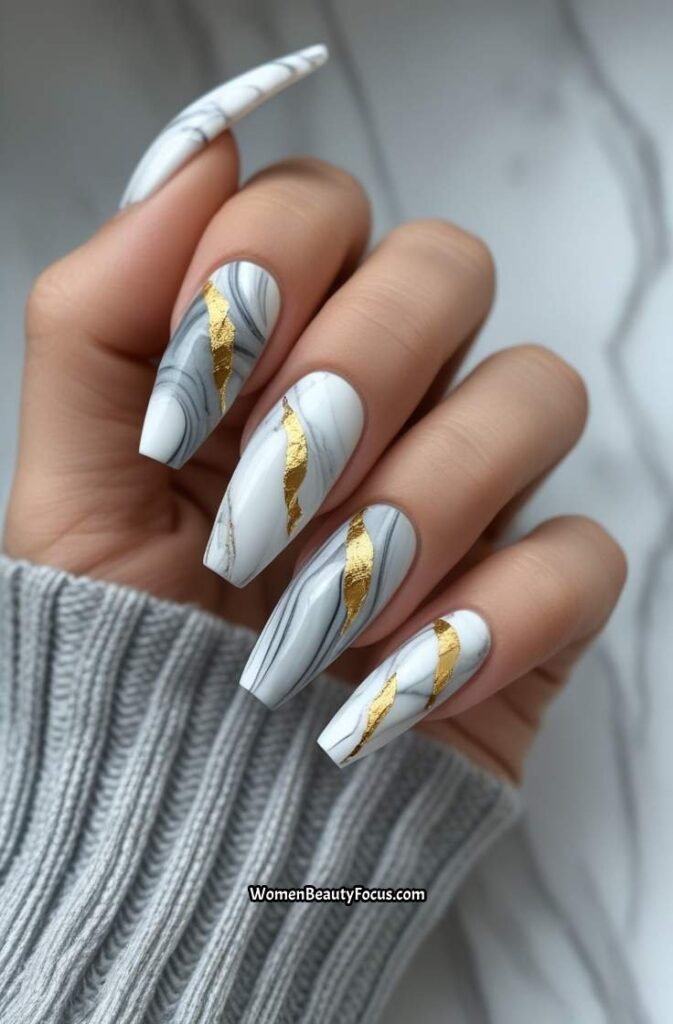 15. Marble Effect Nails with Gold Leaf Accents