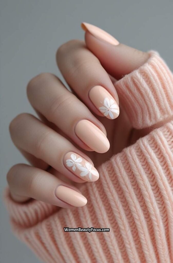 15. Pale Peach Nails with Delicate Floral Patterns
