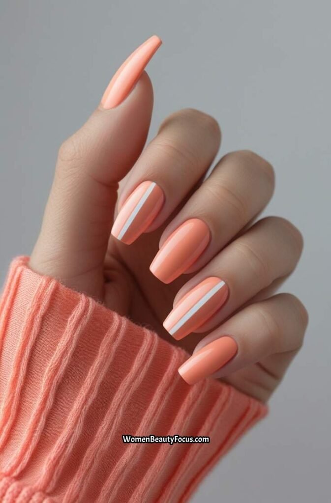 15. Peachy Coral Nails with White Stripes