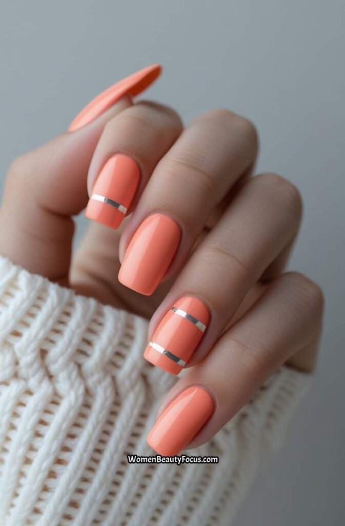15. Soft Coral Nails with Minimalist Silver Stripes