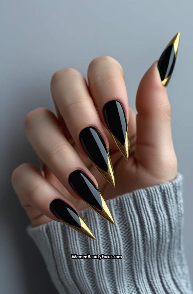 16. Black and Gold Stiletto Nails