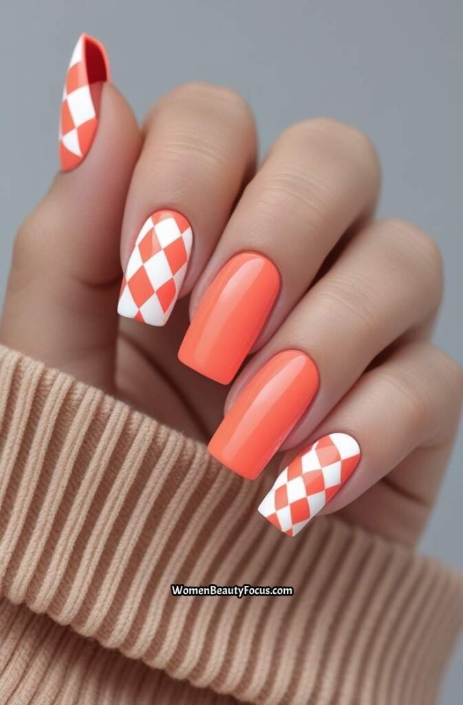 16. Bright Coral Nails with Checkerboard Accents