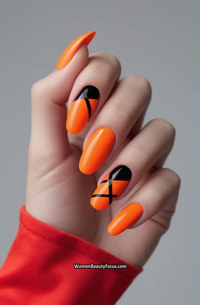 16. Bright Orange Nails with Black Stripes