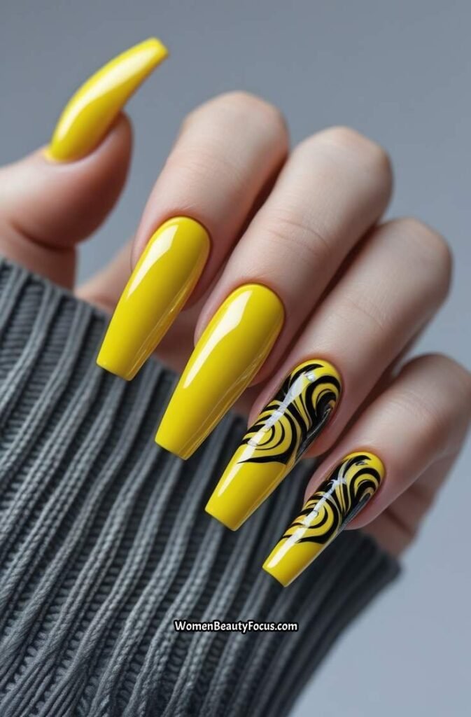 16. Chrome Yellow Nails with Black Swirls