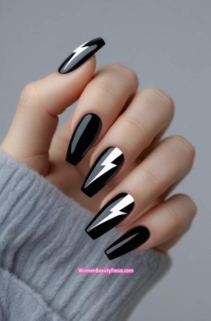 16. Glossy Black Nails with White Lightning Bolts