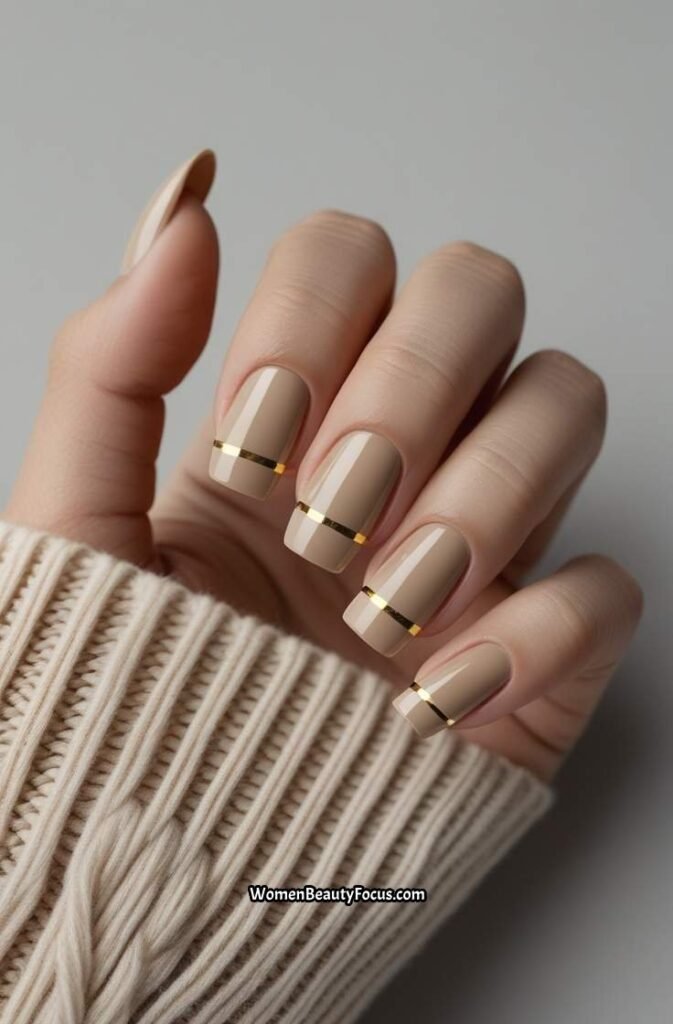 16. Neutral Nails with Thin Gold Stripes