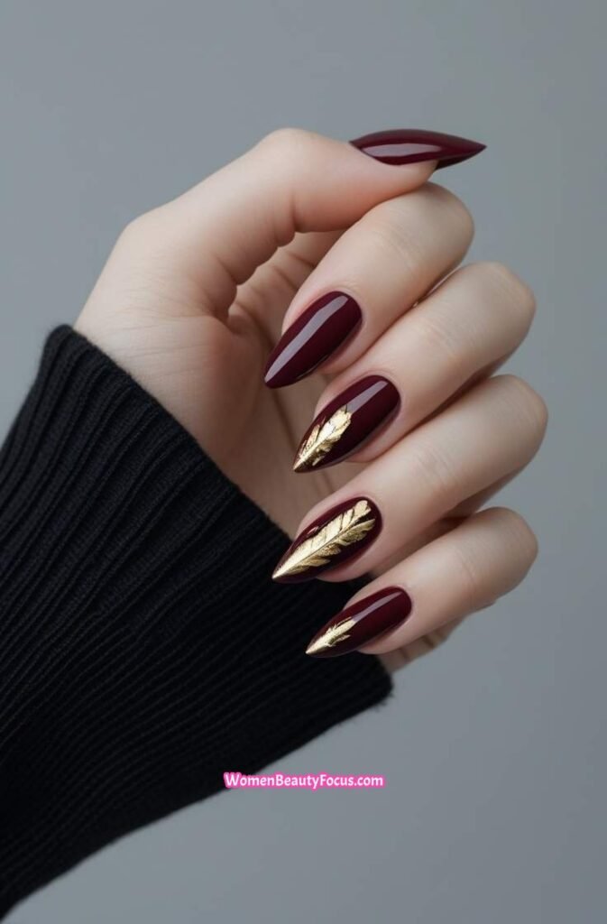 17. Burgundy Stiletto Nails with Gold Leaf Detailing 16 IMGCentury