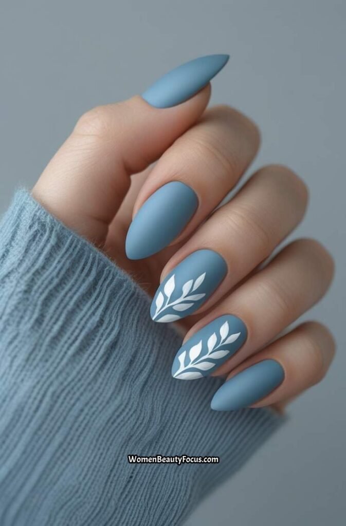 17. Soft Blue Matte Nails with Leaf Accents