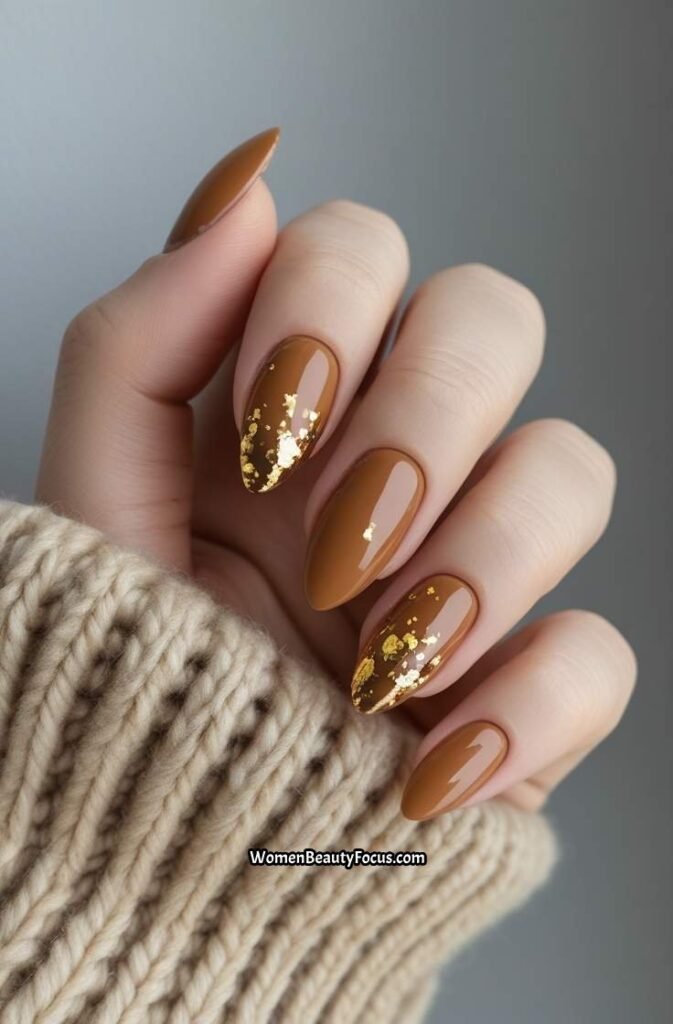 17. Soft Caramel Almond Nails with Gold Foil Flecks