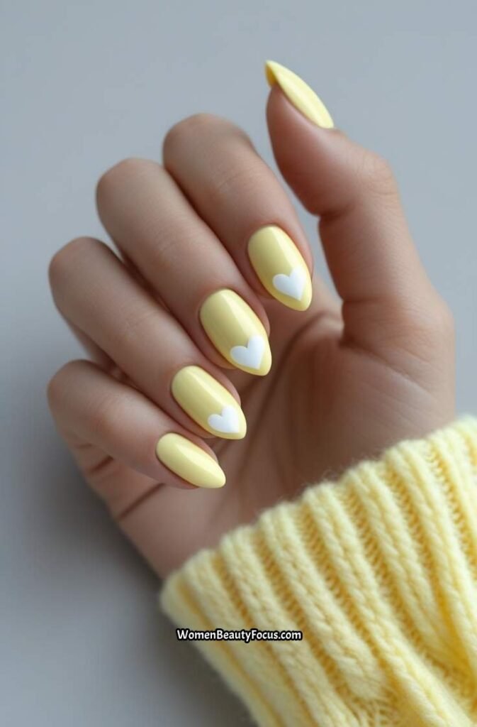 17. Soft Yellow Nails with White Heart Details