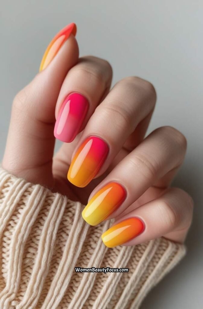17. Vibrant Sunset Nails with Gradient Effect