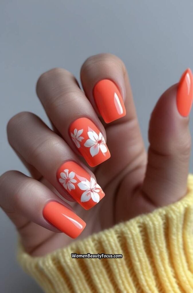 18. Coral Nails with White Floral Design