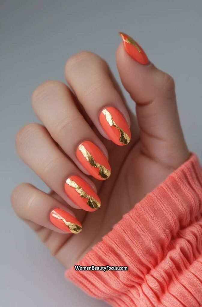 18. Shimmery Coral and Gold Nails
