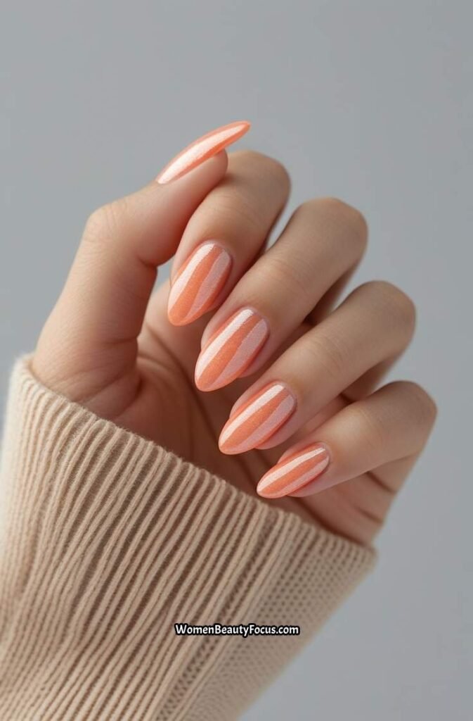 18. Soft Coral Almond Nails with Pearlescent Glow