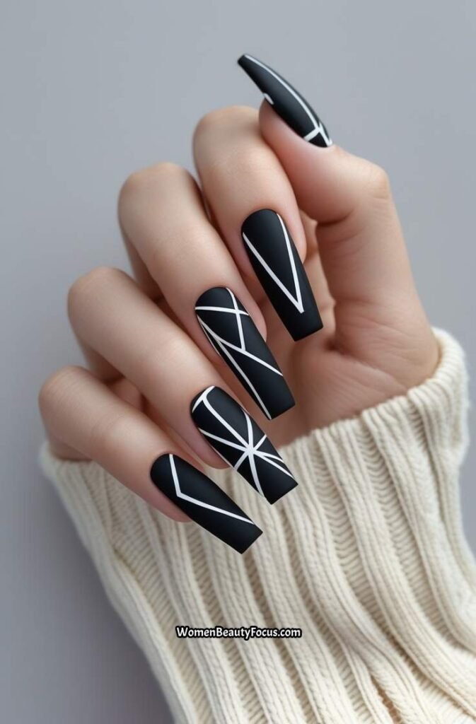 19. Black Nails with White Geometric Lines