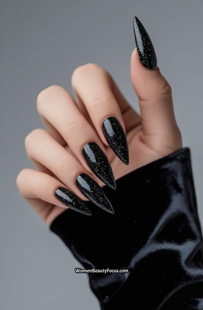 19. Glittery Black Stiletto Nails