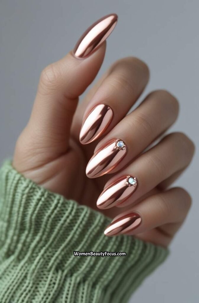 19. Rose Gold Almond Nails with Rhinestone Detail