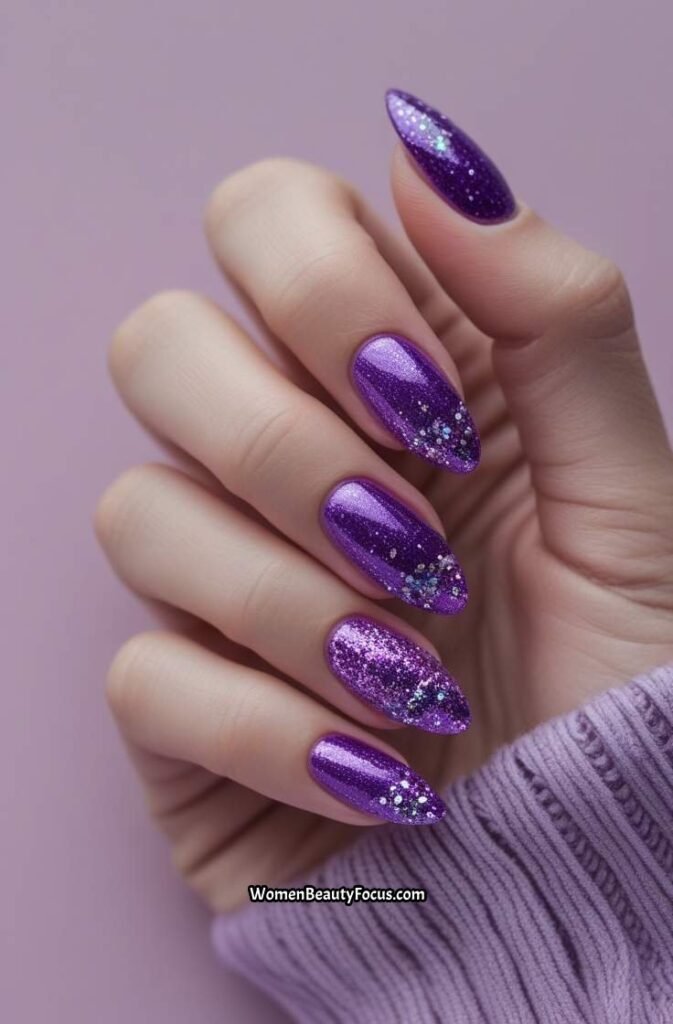 19. Vibrant Purple Nails with Glitter Highlights
