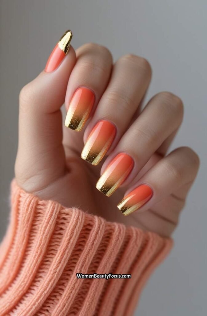 2. Coral Sunset Nails with Gold Tips