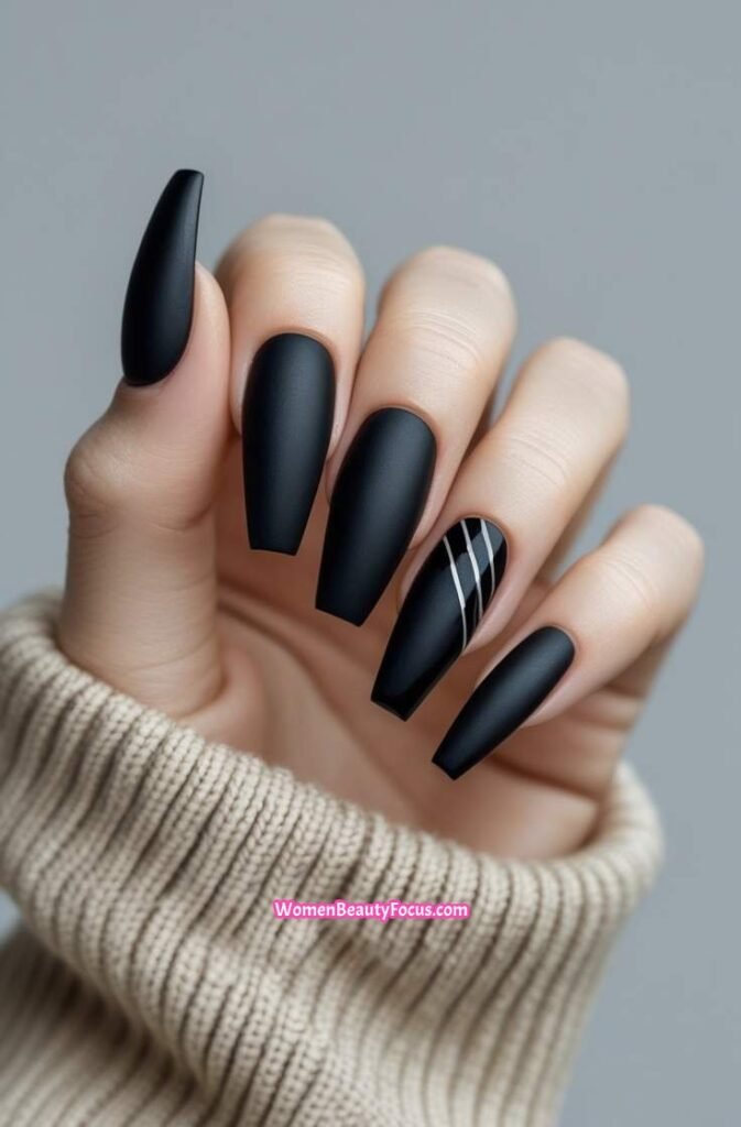 2. Matte Black Coffin Nails with Minimalist Stripes
