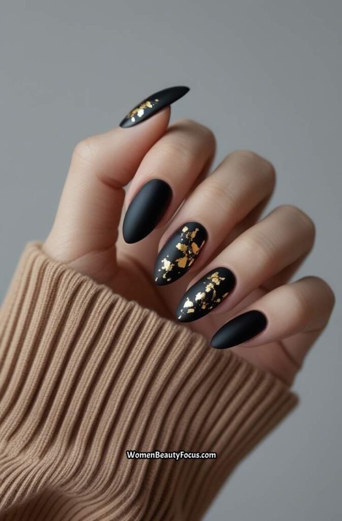 2. Matte Black Nails with Gold Flakes