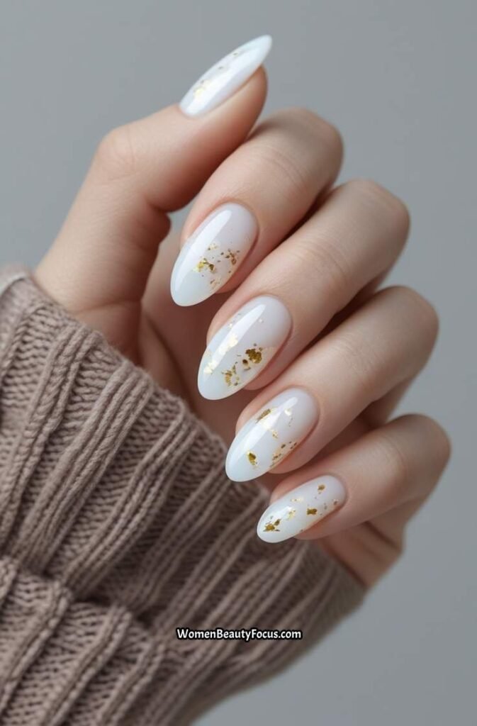 2. Milky White Nails with Gold Flakes