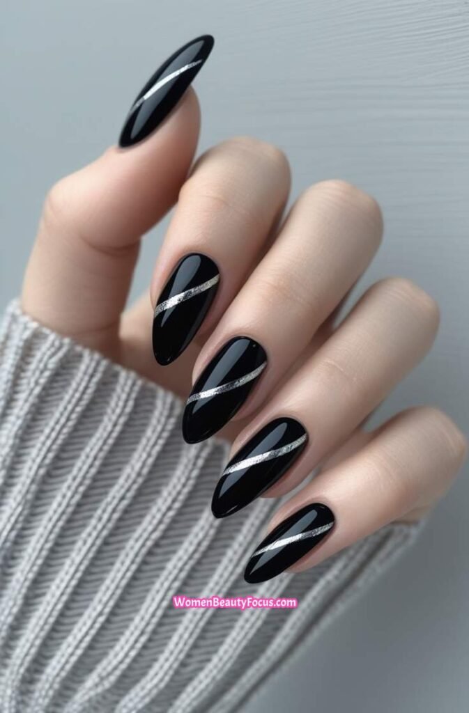 2. Sleek Black Cat Eye Nails with Silver Streaks