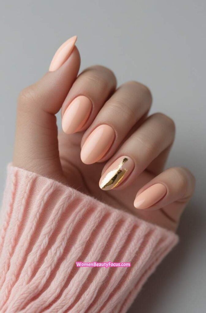 2. Soft Peach and Gold Accent Nails