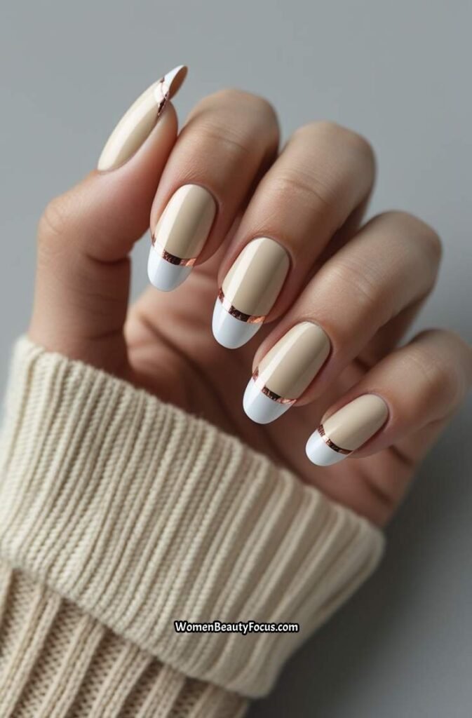 20. Creamy Beige French Tip Nails with Rose Gold Detailing