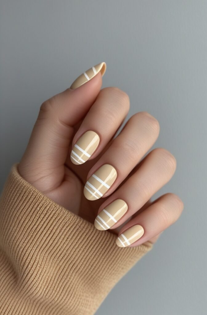 20. Creamy Beige Nails with Thin White Stripes