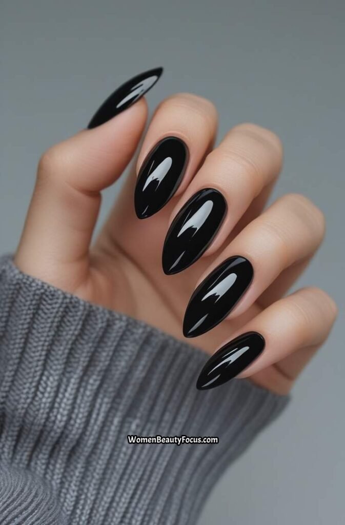 20. Glossy Jet Black Almond Nails