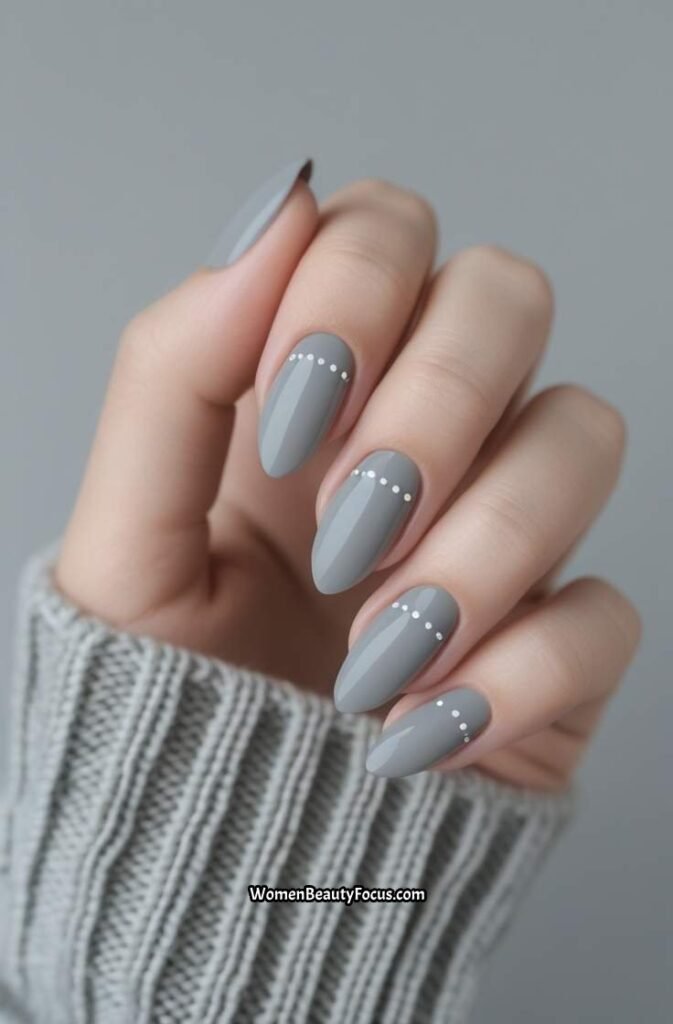 20. Neutral Grey Almond Nails with Minimal White Dots