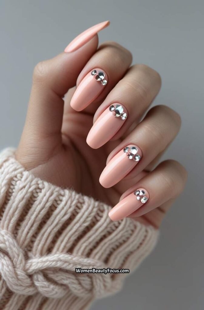 20. Peachy Pink Nails with Crystal Embellishments