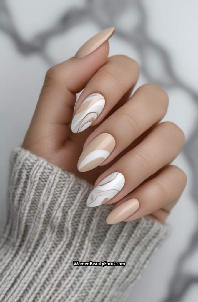 20. Soft Beige Almond Nails with Marble Swirls