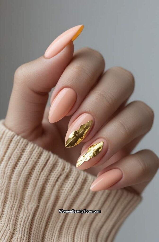 20. Soft Peach Nails with Gold Leaf Accents