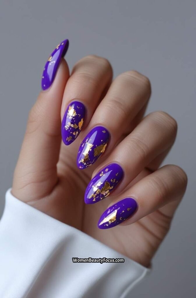 21. Bright Purple Nails with Gold Foil Flakes