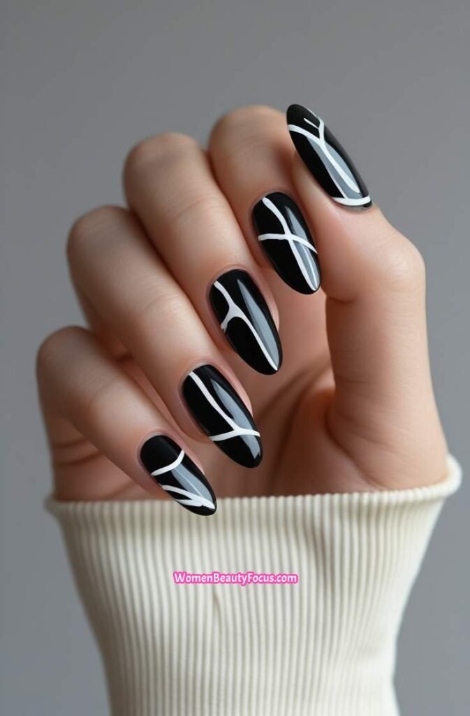 21. Glossy Black Nails with Abstract White Lines