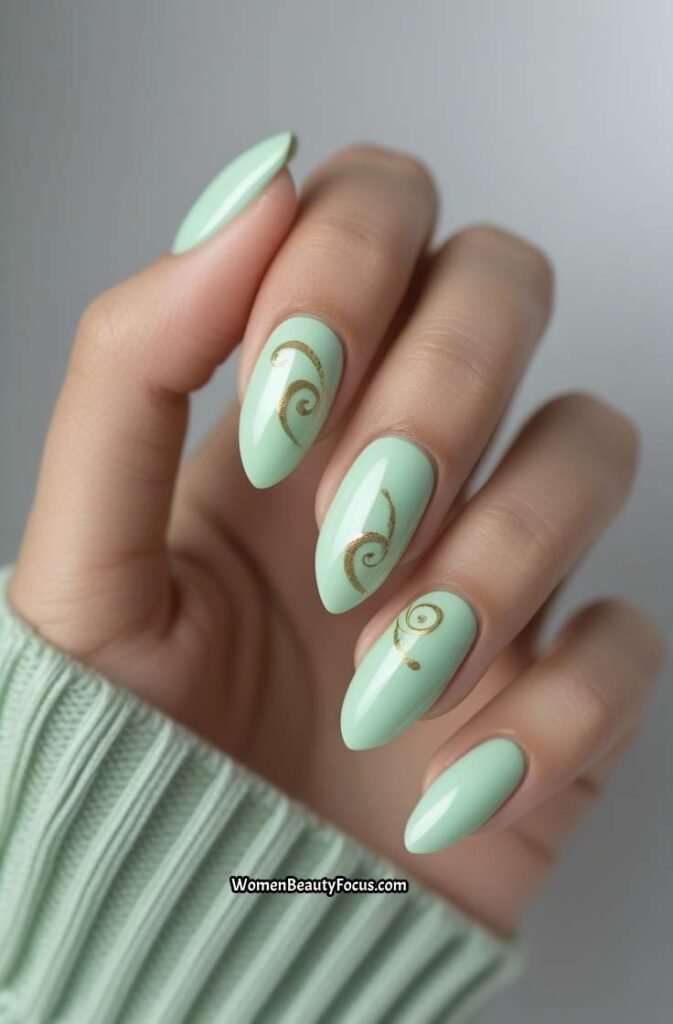 21. Mint Green Nails with Gold Swirls