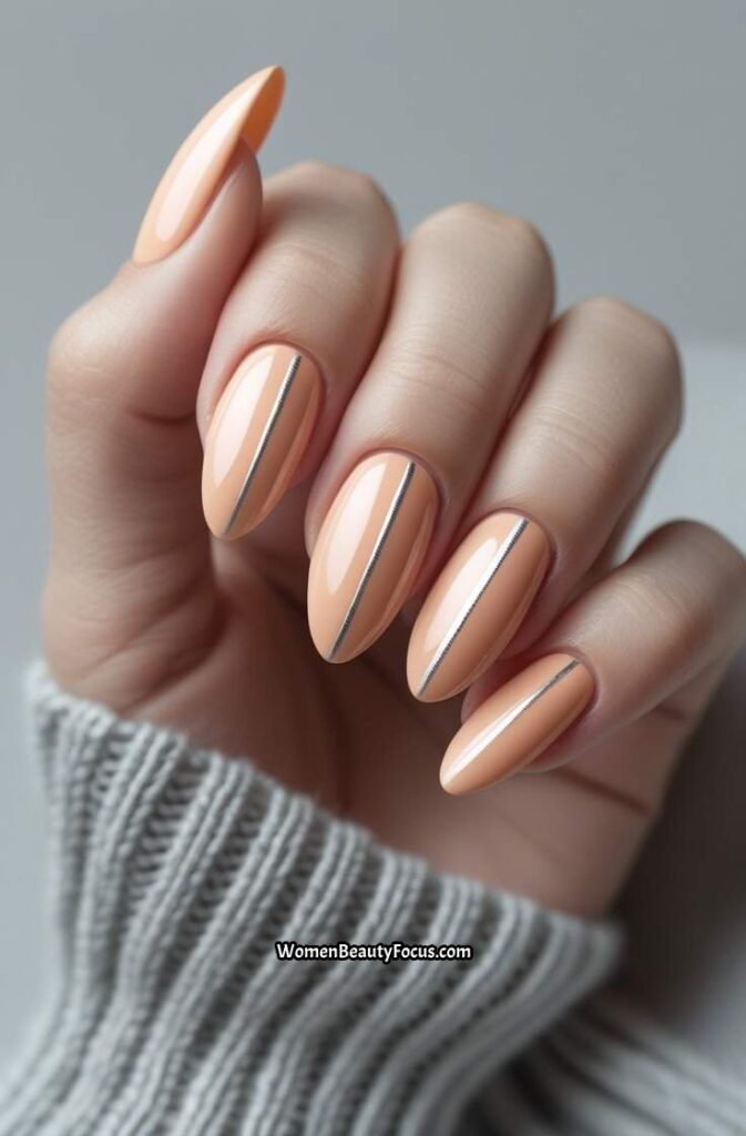 21. Soft Peach Almond Nails with Silver Lines