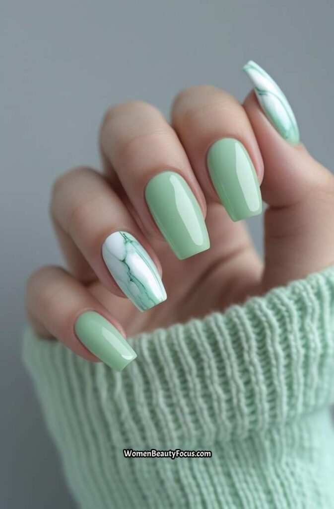 22. Pastel Green Nails with Marble Accent