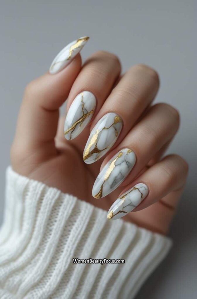 23. Elegant Marble and Gold Nails