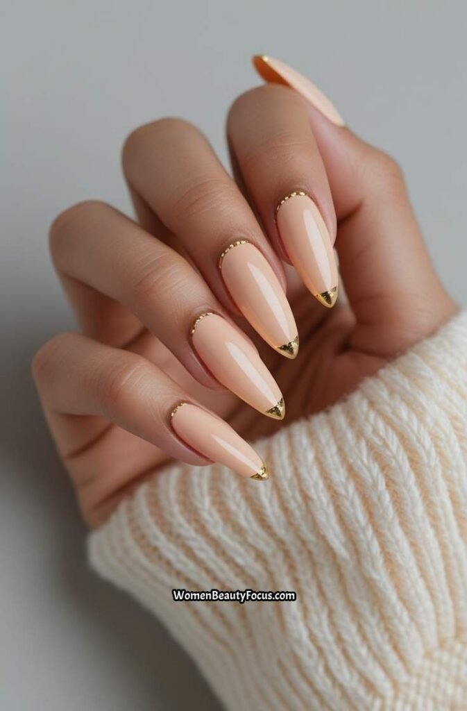 23. Pale Peach Almond Nails with Gold Accents