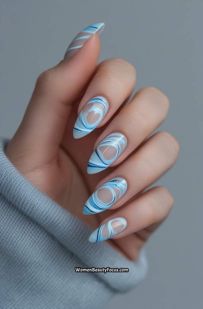 24. Icy Blue Swirl Nails