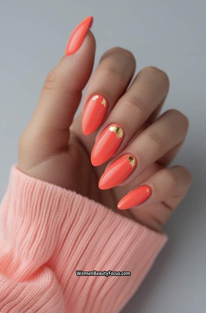 3. Coral Almond Nails with Gold Foil Detailing