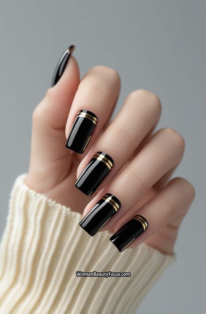 3. Glossy Black Nails with Gold Striping Tape