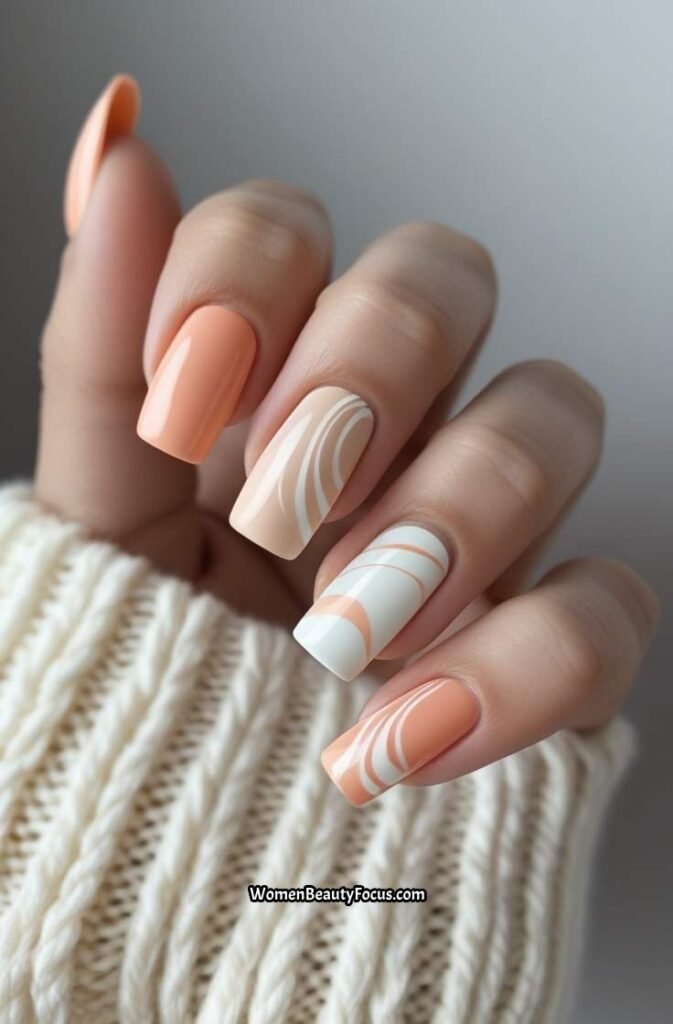 3. Peach and Neutral Swirl Nails