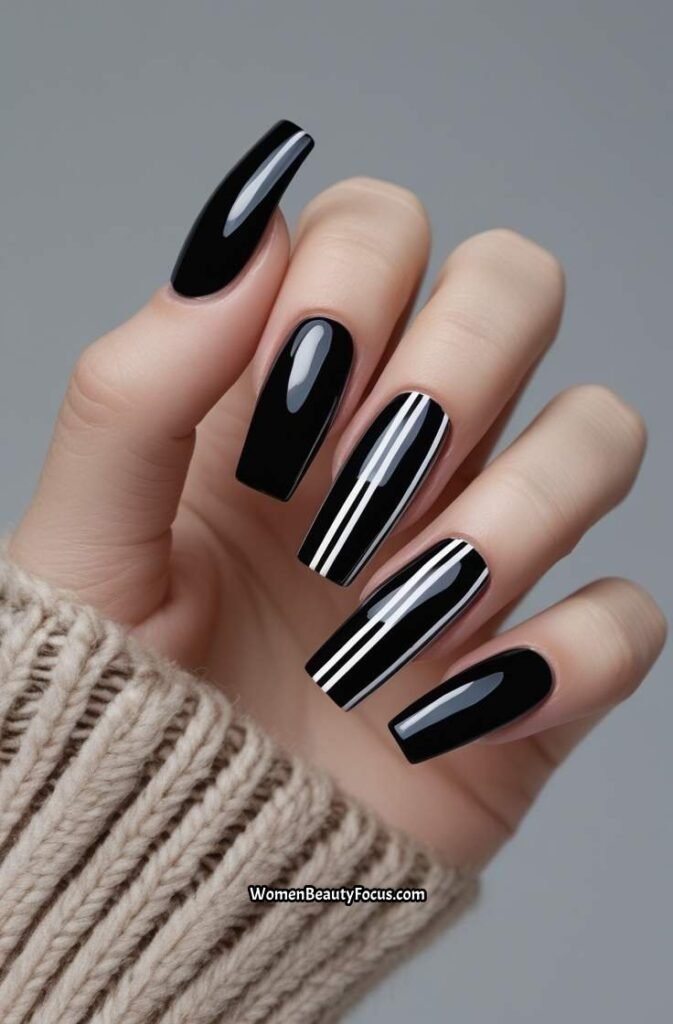 5. Bold Black Nails with White Stripes