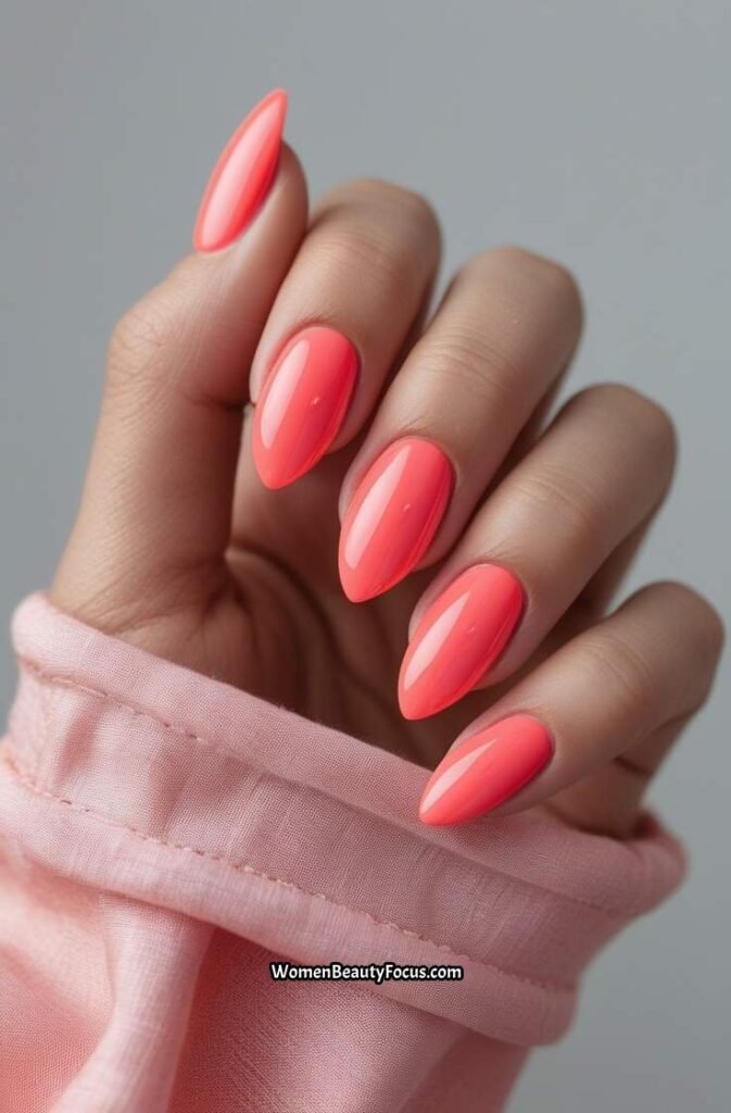 5. Coral Pink Almond Nails with Shiny Finis