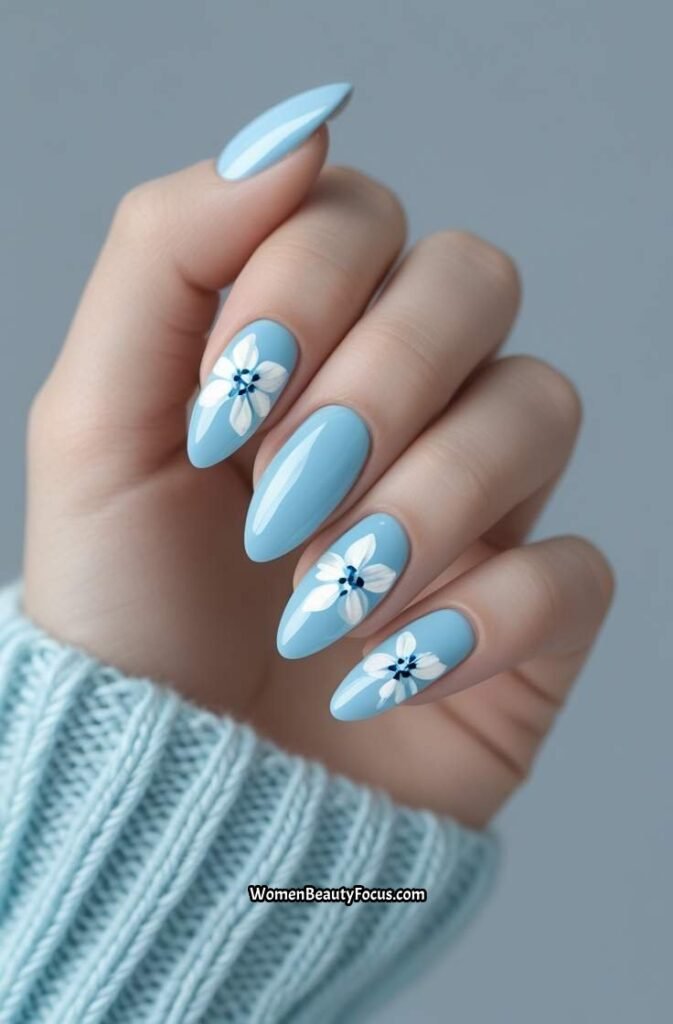 5. Glossy Baby Blue Nails with White Floral Accents